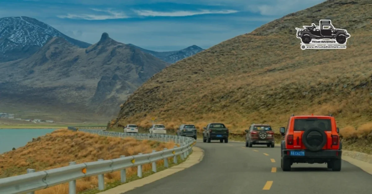 A convoy driving towards Lhasa from India next to Yamdrok Lake.